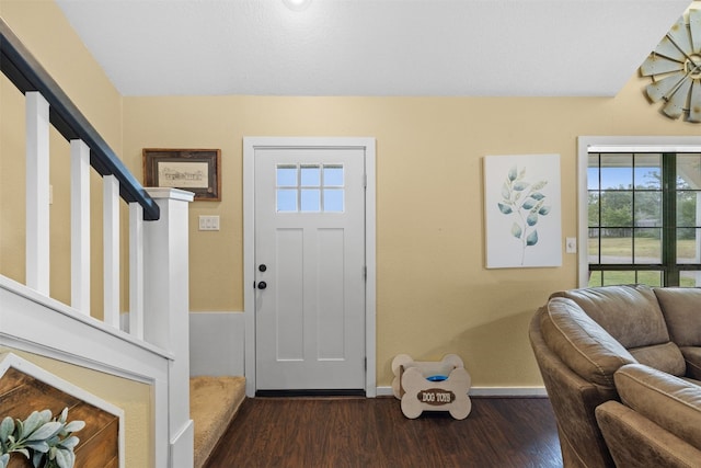 entryway with dark hardwood / wood-style flooring