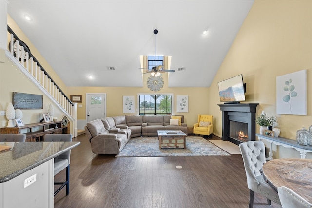 living room featuring ceiling fan, dark hardwood / wood-style floors, and high vaulted ceiling