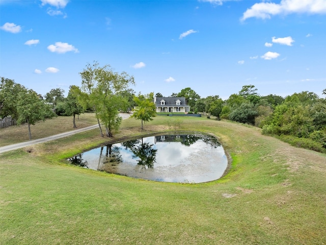 view of community with a water view and a yard