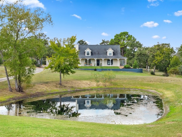 exterior space with a water view and a yard