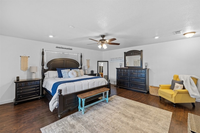 bedroom featuring a textured ceiling, ceiling fan, and dark hardwood / wood-style floors