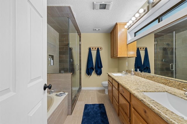 full bathroom with independent shower and bath, toilet, a textured ceiling, and vanity