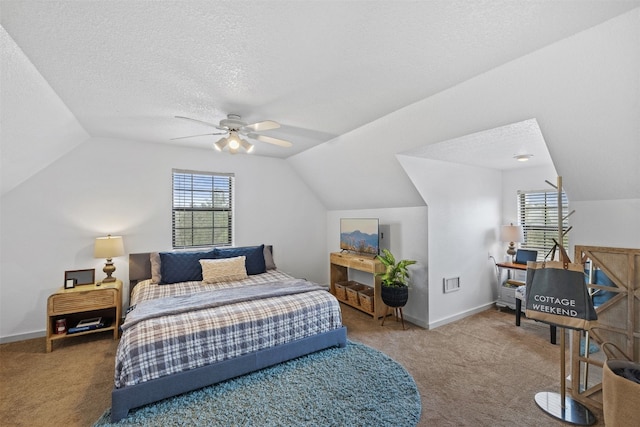 carpeted bedroom featuring lofted ceiling, multiple windows, and ceiling fan