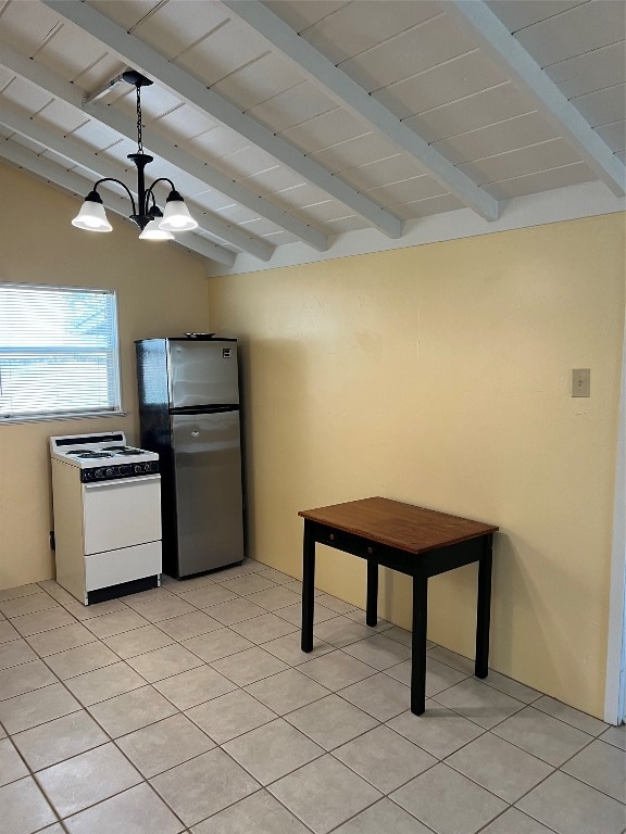 kitchen featuring pendant lighting, lofted ceiling with beams, white range, a notable chandelier, and stainless steel fridge