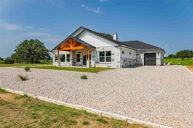 view of front of property with a garage and a front lawn