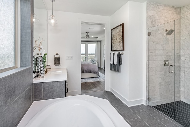 bathroom featuring tile patterned flooring, vanity, separate shower and tub, and ceiling fan