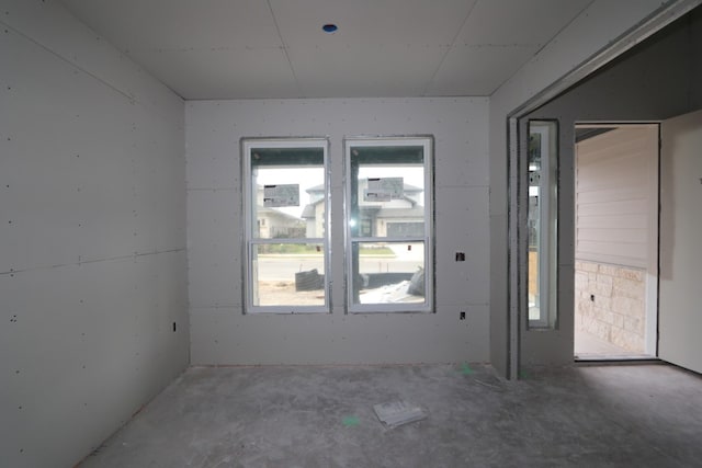 spare room with concrete flooring