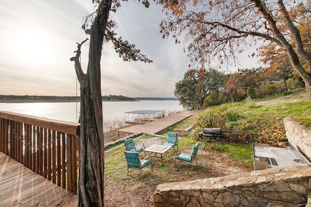 view of dock featuring a deck with water view