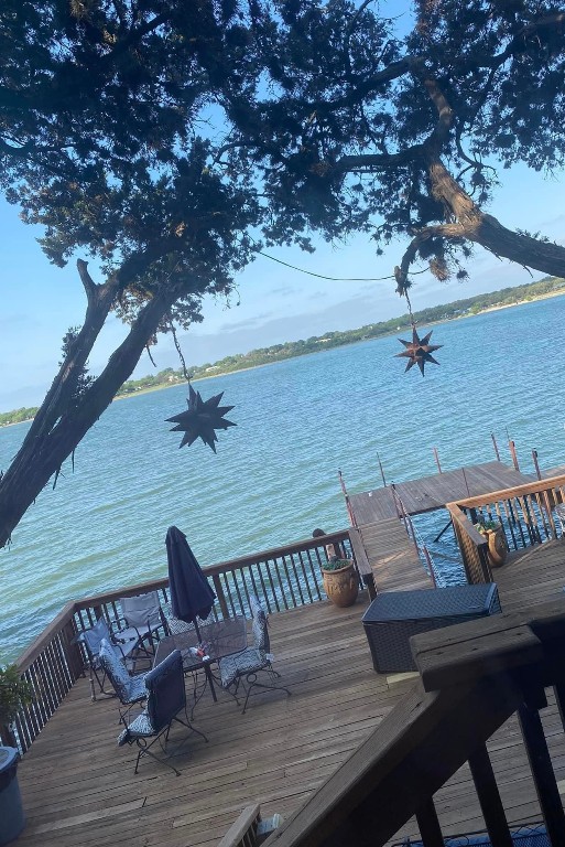 dock area featuring a deck with water view