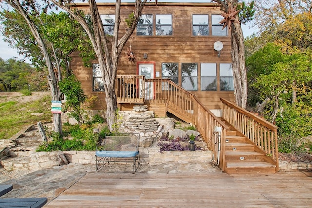 back of property featuring a wooden deck