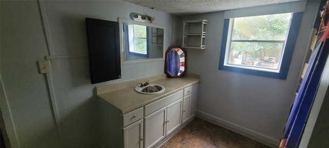 bathroom with vanity and a textured ceiling