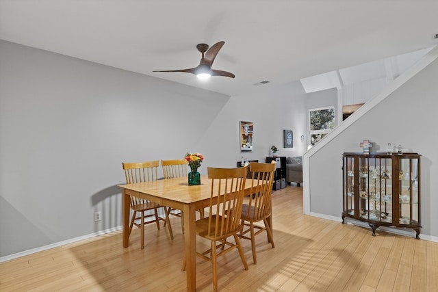 dining room featuring light hardwood / wood-style flooring, lofted ceiling, and ceiling fan