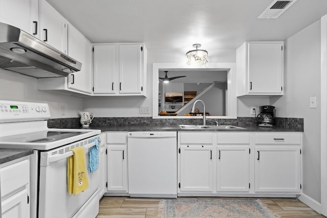 kitchen with white appliances, white cabinetry, sink, and light hardwood / wood-style flooring