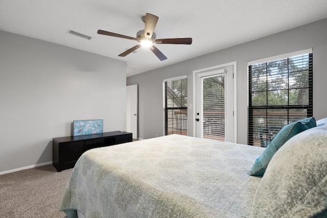 bedroom with ceiling fan, carpet floors, access to outside, and a textured ceiling