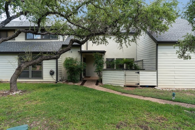 rear view of house featuring a lawn