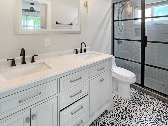 bathroom with an enclosed shower, tile patterned floors, toilet, ceiling fan, and vanity