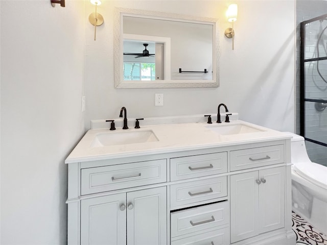 bathroom with a shower with door, vanity, toilet, and ceiling fan