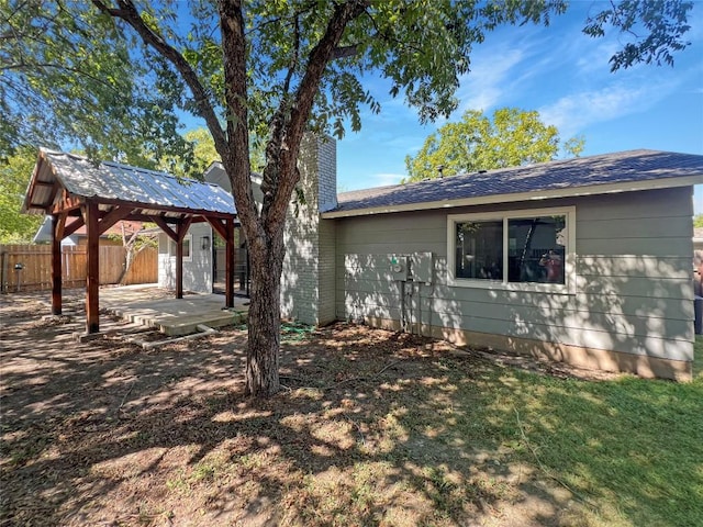 9614 Newfoundland Cir, Austin, TX 78758 - view of side of property with a gazebo, a chimney, and a patio