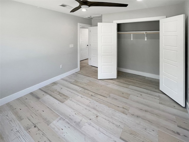 unfurnished bedroom featuring light hardwood / wood-style flooring, ceiling fan, and a closet