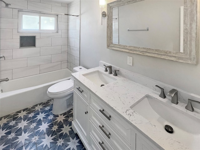 full bathroom featuring vanity, toilet, and tiled shower / bath