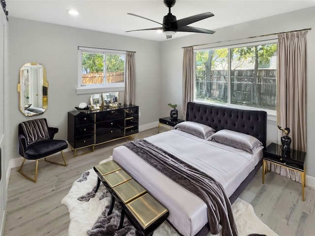 bedroom with ceiling fan and light hardwood / wood-style flooring