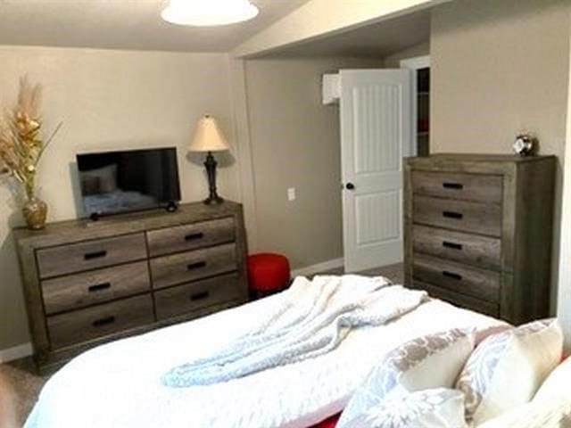 bedroom with lofted ceiling