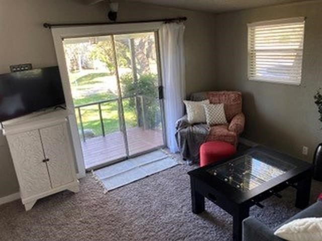 carpeted living room with ceiling fan