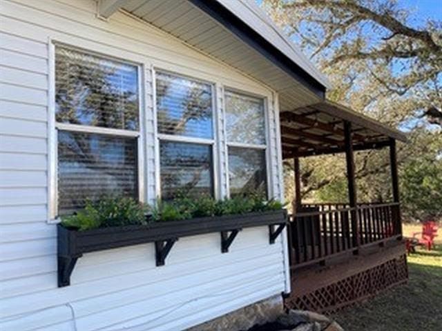 view of side of home with a deck