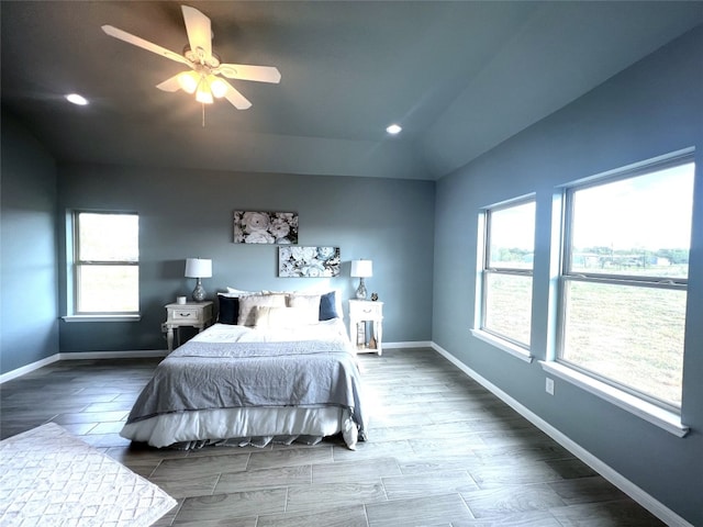 bedroom featuring ceiling fan, wood-type flooring, and vaulted ceiling