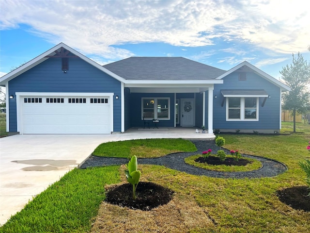 ranch-style house with covered porch, a front yard, and a garage