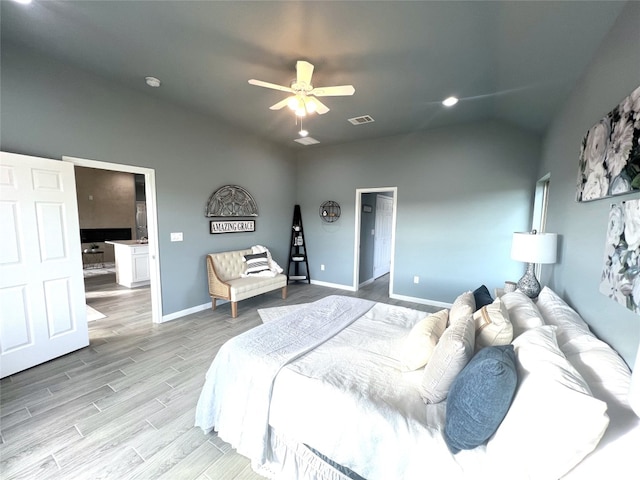 bedroom featuring ceiling fan, vaulted ceiling, and light hardwood / wood-style floors