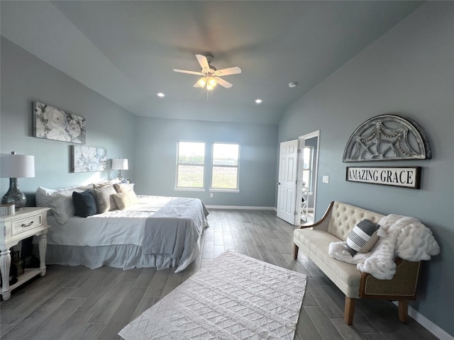 bedroom with ceiling fan, dark hardwood / wood-style floors, and vaulted ceiling