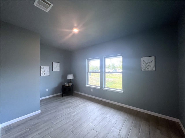 unfurnished room with light hardwood / wood-style flooring