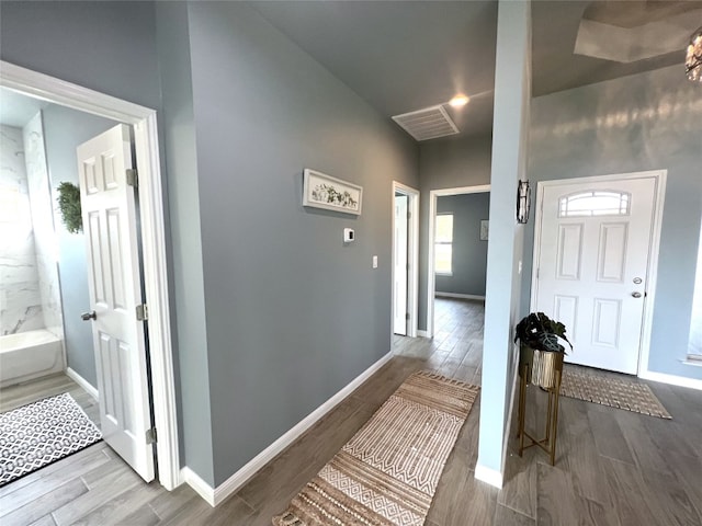 hall with hardwood / wood-style floors