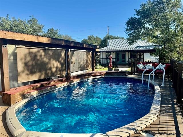 view of pool with an outbuilding