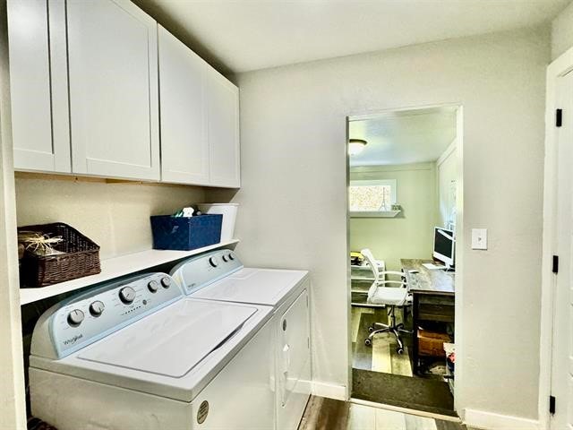 laundry room featuring hardwood / wood-style flooring, cabinets, and independent washer and dryer