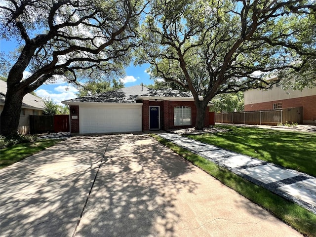 ranch-style home with a garage and a front lawn