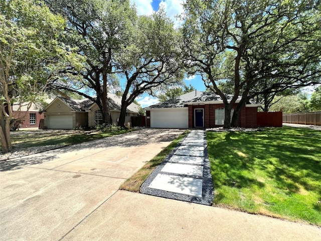 ranch-style house with a garage and a front yard