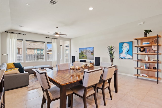 dining space featuring ceiling fan and vaulted ceiling