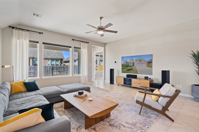 tiled living room featuring ceiling fan and vaulted ceiling