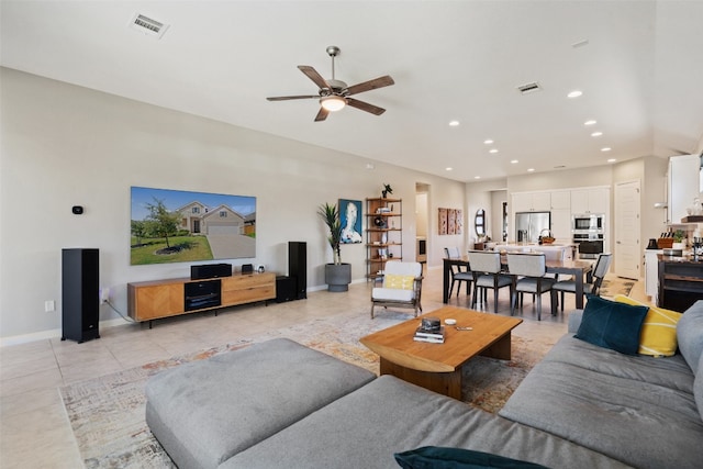 living room with ceiling fan and light tile patterned floors