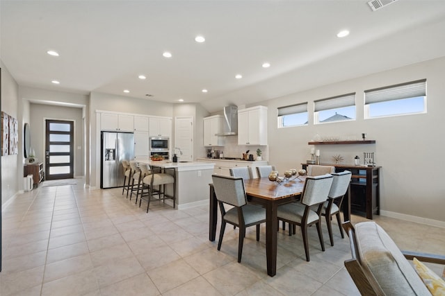 tiled dining space featuring sink