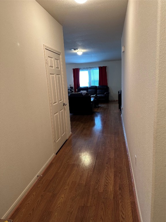 hallway with wood-type flooring