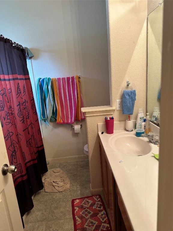 bathroom with tile patterned floors, a shower with curtain, toilet, and vanity