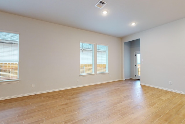 empty room with light hardwood / wood-style flooring