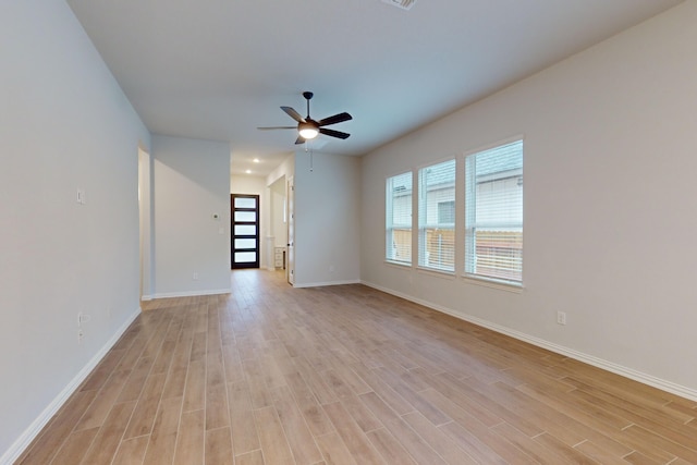 spare room featuring light wood-type flooring and ceiling fan