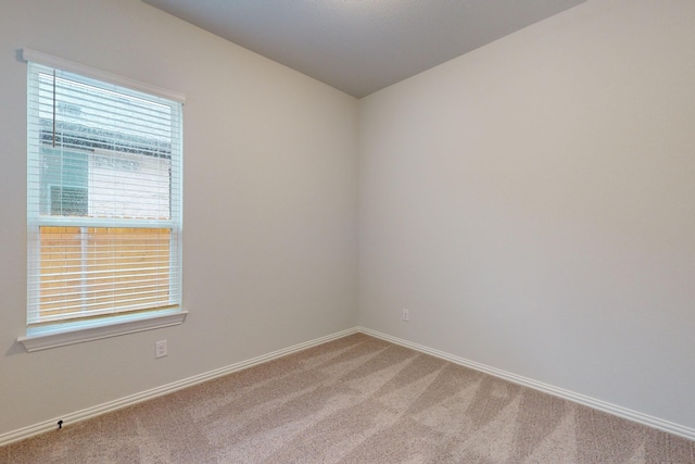 spare room with light colored carpet