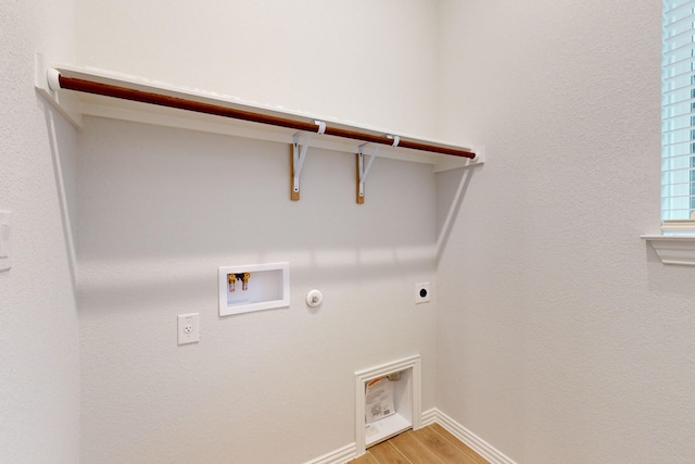 clothes washing area featuring washer hookup, light hardwood / wood-style floors, gas dryer hookup, and electric dryer hookup