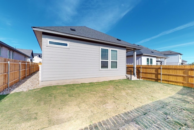 rear view of house with a lawn