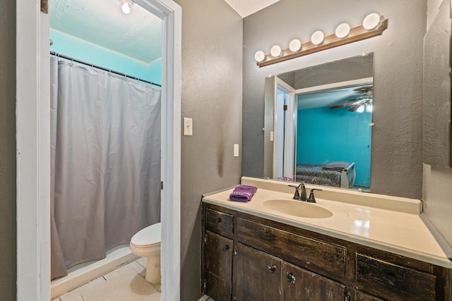 bathroom featuring vanity, a shower with shower curtain, tile patterned flooring, toilet, and ceiling fan